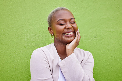 Buy stock photo Happy, calm and young black woman by a green wall with trendy, classy and elegant jewelry and outfit. Fashion, smile and peaceful African female model with happiness, positive and confident attitude.