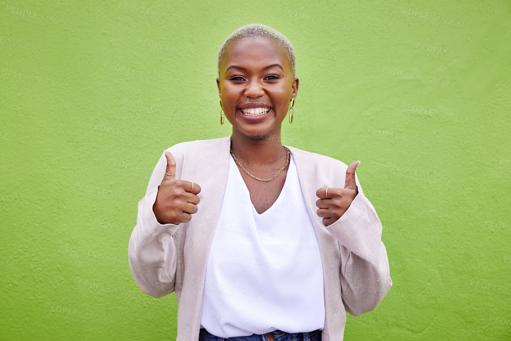 Buy stock photo Happy, thumbs up and portrait of black woman by a green wall with classy and elegant jewelry and outfit. Happiness, excited and African female model with positive and confident attitude with fashion.