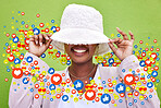 Social media, smile and emoji icon of woman influencer for like or love reaction. Person hiding under hat for fan page, content creator app or communication notification overlay on green background
