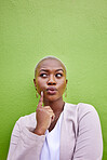 Thinking, idea and young black woman by a green wall with trendy, classy and elegant jewelry and outfit. Dreaming, mindful and African female model with positive and confident attitude with fashion.