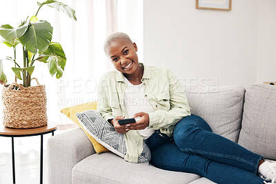 Buy stock photo Portrait, woman and typing with phone on sofa for social media, chat and online notification at home. Happy african person relax with smartphone, download mobile games or scroll on digital multimedia