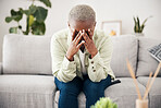 Woman, depression and crying on sofa for anxiety, mental health and stress of bad mistake at home. Doubt, sad and frustrated african person scared of trauma, headache and counselling of broken heart