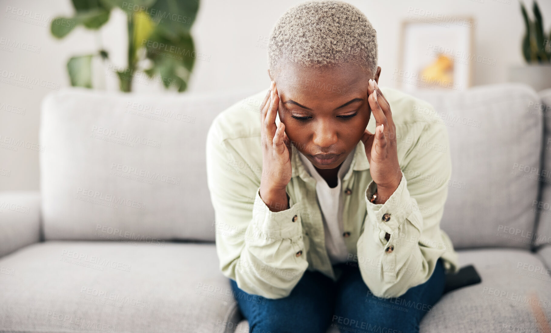 Buy stock photo Burnout, headache and pain with a black woman on a sofa in the living room of her home for mental health. Anxiety, stress or vertigo and a young person in an apartment with depression or a migraine