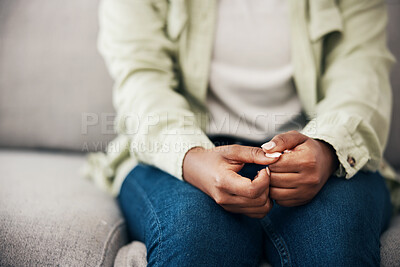 Buy stock photo Stress, hands and woman on a sofa with anxiety, worry or mental health crisis in her home. Depression, trauma and zoom on female with bipolar, fear or abuse, danger or nervous nail picking habit