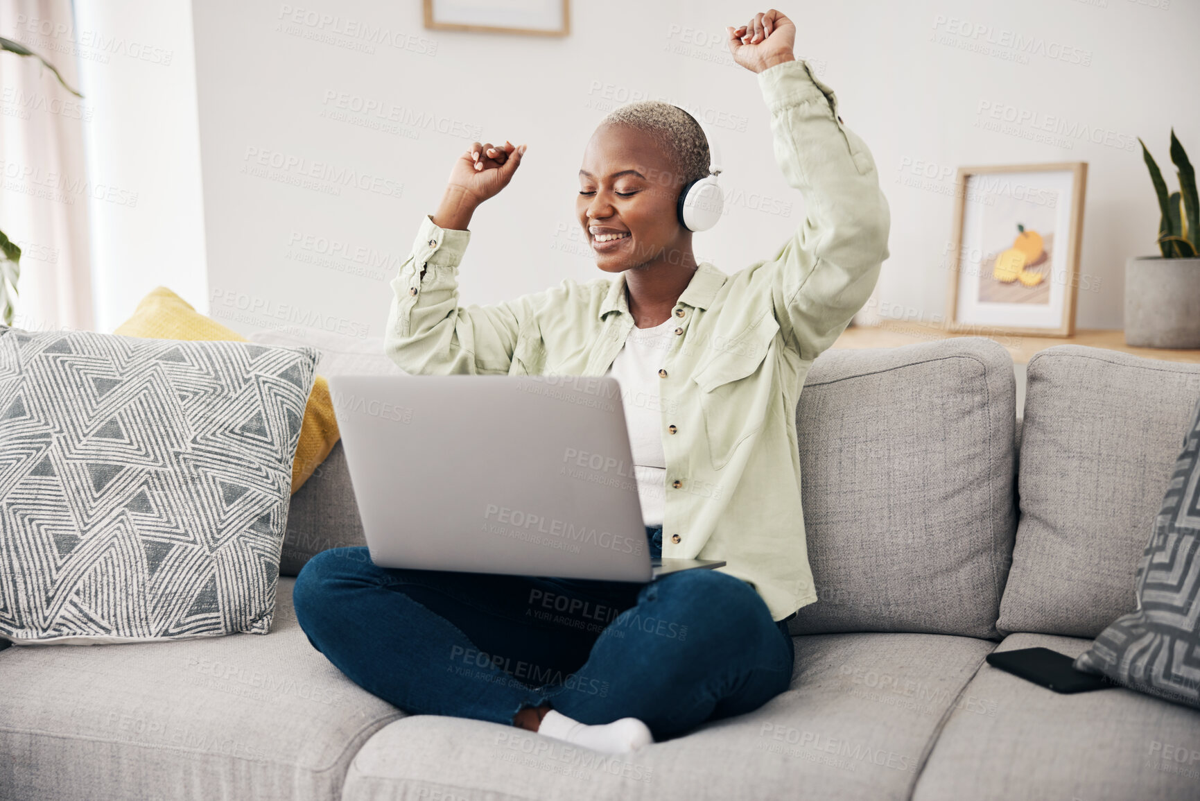 Buy stock photo Music, dance and black woman with laptop on sofa with headphones, happy and free at home. Radio, earphones and African female dancing to online feel good podcast in living room smile for subscription