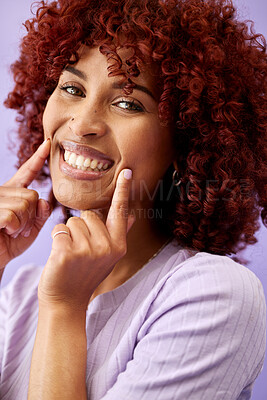Buy stock photo Hair, beauty and woman with hands on face in studio for natural, cosmetic or wellness on purple background. Haircare, portrait and lady model smile for red afro growth, texture or dye satisfaction