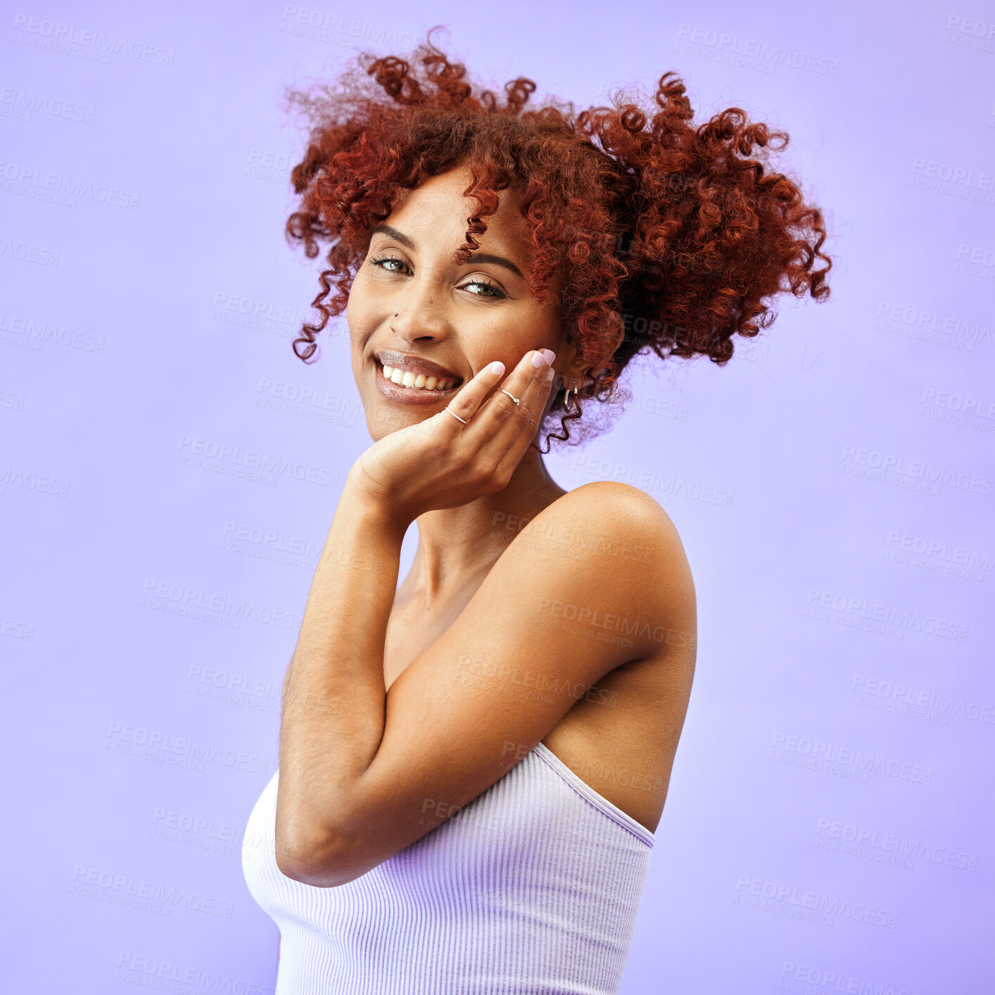 Buy stock photo Hand on face, natural beauty and woman, hair care and wellness with smile isolated on purple background. Dermatology, haircare and cosmetics, portrait with red curls and skin glow in a studio