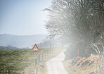 UFO sign, spaceship and mist road in nature for alien warning, science fiction and abduction. Area 51, travel and signage for extraterrestrial caution in countryside, meadow and natural landscape 