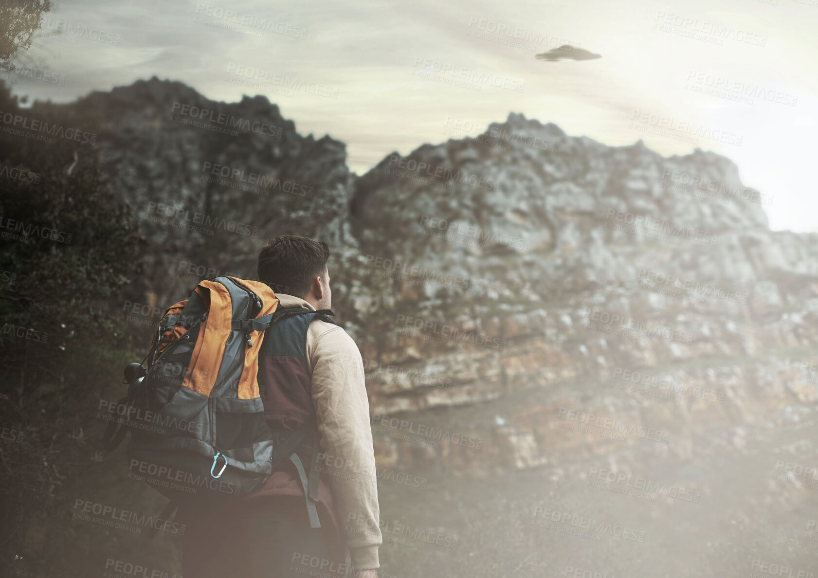 Buy stock photo Hiking, man and ufo at mountains, spaceship or mystery adventure in countryside to travel. Trekking, alien and back of person with flying saucer, science fiction or extraterrestrial conspiracy theory