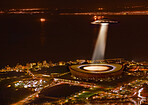 UFO, lights and city in night, buildings and alien invasion for search, stadium or Cape Town. UAP spaceship, flying saucer or tractor beam in dark cityscape, metro or cbd for survey, flight or sci fi