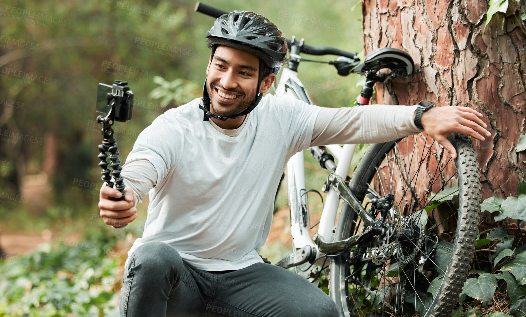 Buy stock photo Man, selfie and bike by trees, forest and smile for training, health and outdoor adventure with web blog. Influencer guy, cycling and bicycle with live stream, profile picture and social media post