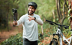 Man, bike and forest with selfie, smile and pointing with wellness, training and exercise on adventure. Influencer guy, cycling and bicycle with profile picture, memory or live stream on social media