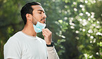 Relief, breathing and a man with a face mask in nature for fitness, running or exercise. Calm, mockup space and an Asian runner or athlete with covid and breathe after running in a park for cardio