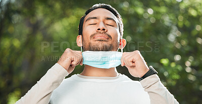 Buy stock photo Covid, Asian man and take off mask for end of pandemic, breathing and outdoor protected. Corona, healthy guy and Japanese person remove face cover for fresh air, freedom and decrease infection rates