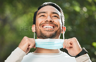 Buy stock photo Corona, Asian man and take off mask for end of pandemic, vaccine safety and outdoor protected. Covid policy, happy guy and Japanese person remove face cover for breathing and decrease infection rates