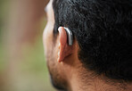 Closeup of hearing aid, ear and man with disability from the back for medical support, listening and healthcare tech. Deaf patient, face and audiology implant to help volume, vibration or sound waves