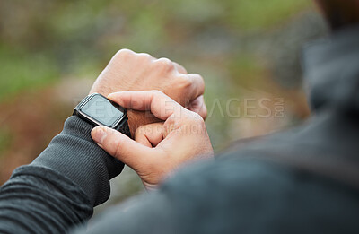 Hand, time and a man hiking in the forest closeup for freedom, travel or adventure outdoor in nature. Watch, fitness and recreation with a hiker in the woods to discover or explore the wilderness
