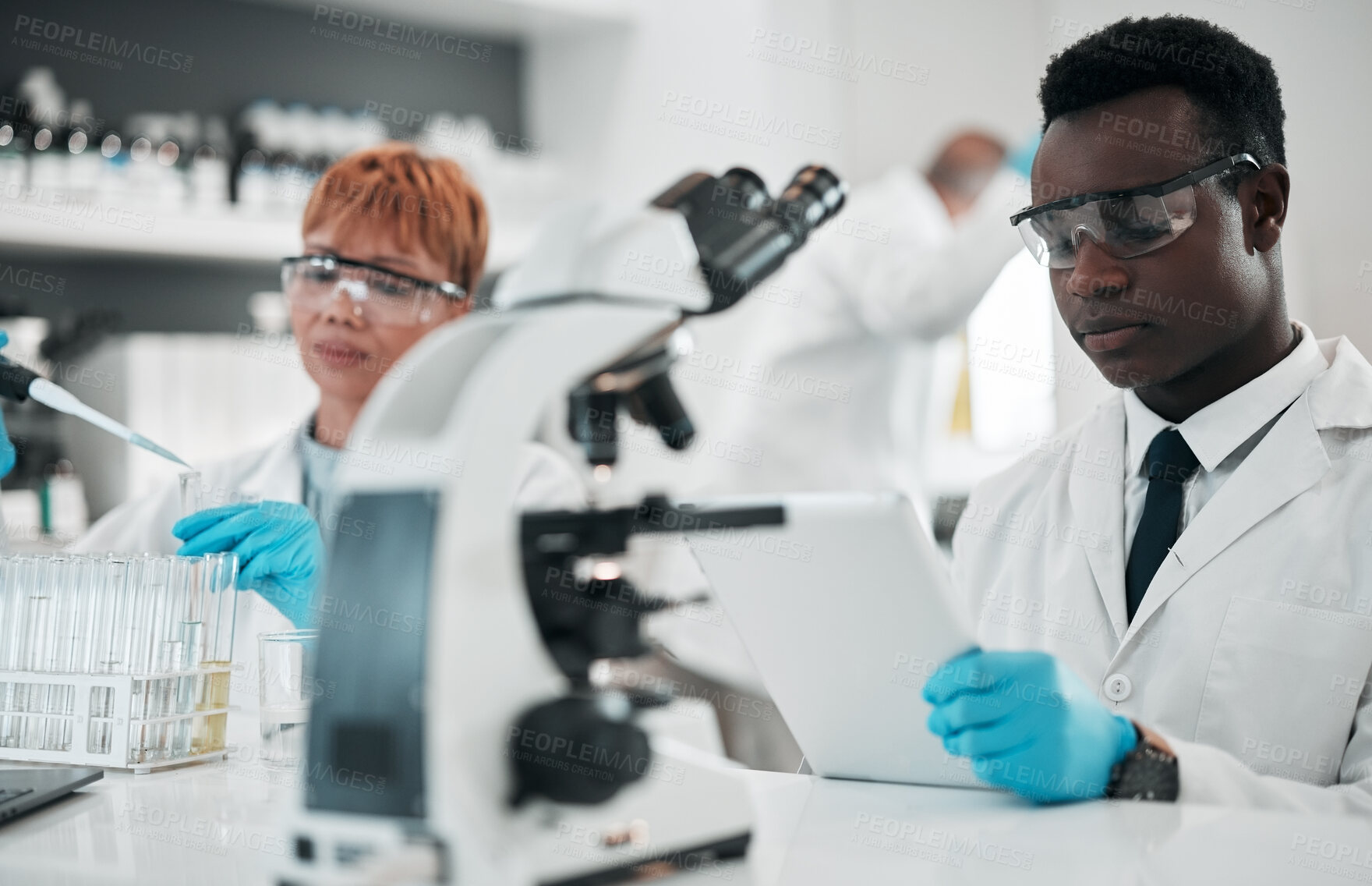 Buy stock photo Science, team and working in laboratory to research solution, chemistry investigation and medical data. Scientist, black man and review information on digital tablet, test results and biotechnology 