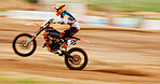 Motorcycle, balance and motion blur with a man training for a race or dirt biking challenge on space. Bike, fitness and power with a person driving fast on an off road course for freedom or speed