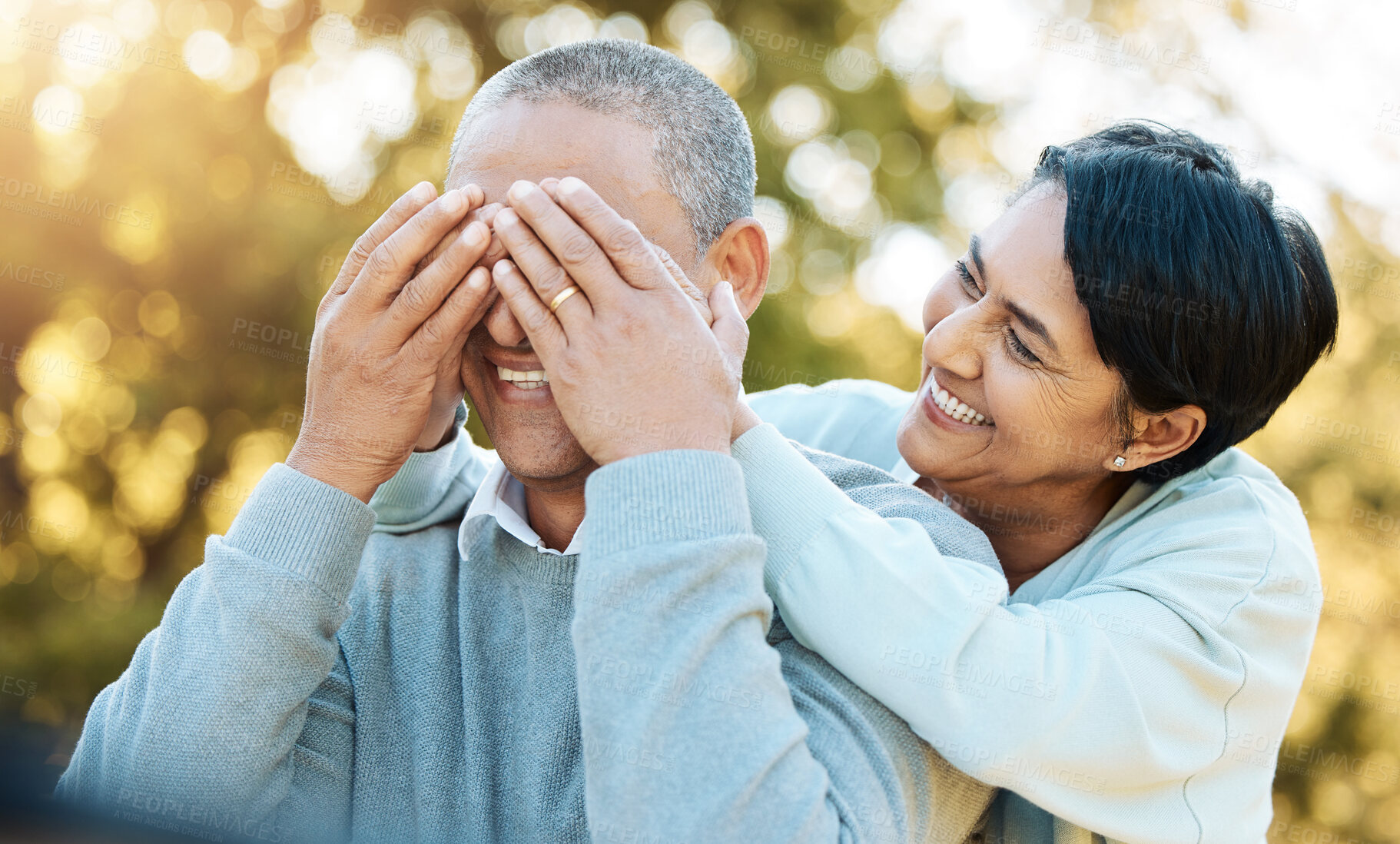 Buy stock photo Outdoor, surprise and senior couple cover eyes, love and retirement with happiness, bonding and marriage. Park, nature or old woman with elderly man, relationship and playful with fun, trust and care