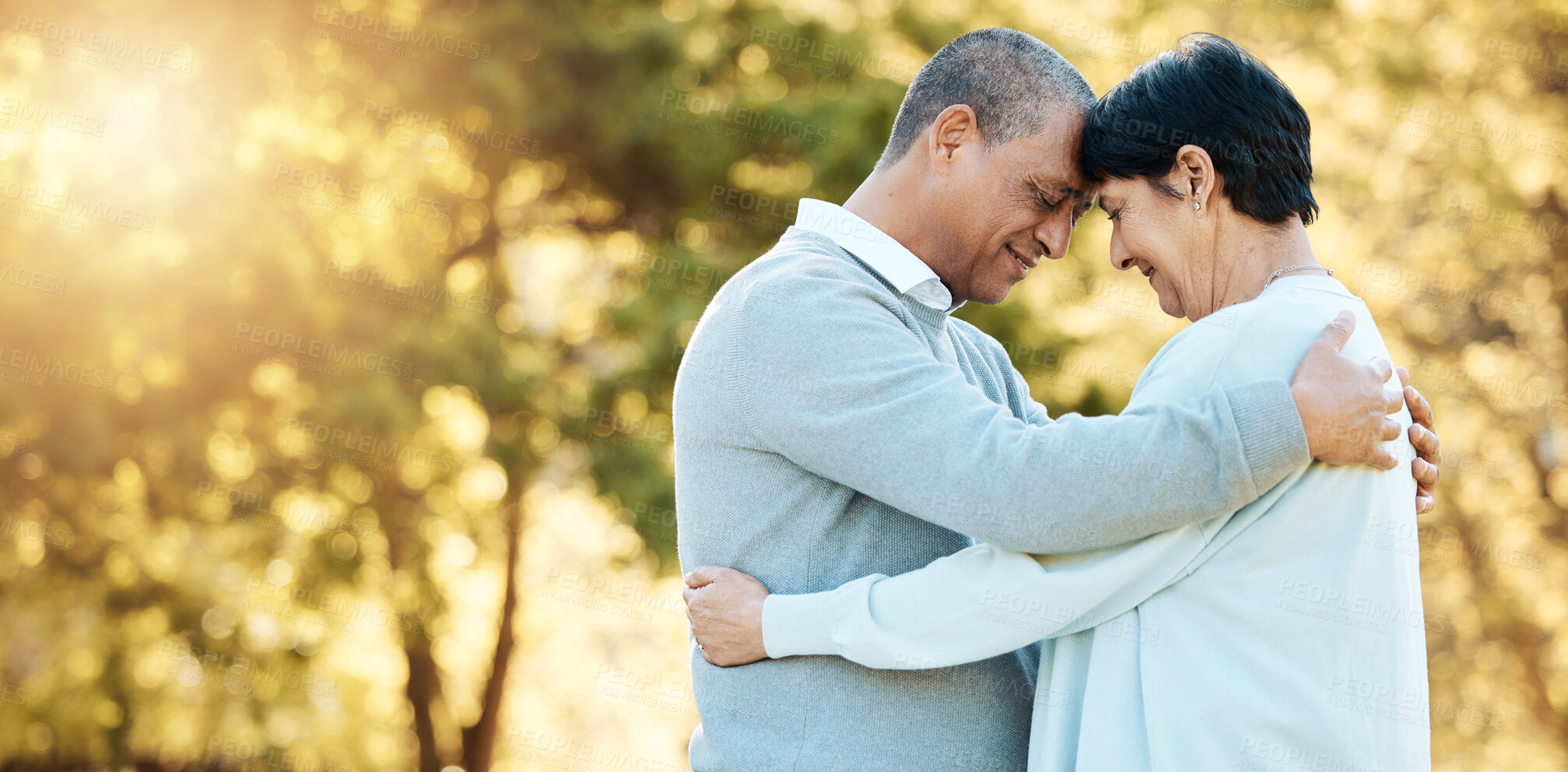 Buy stock photo Love, hug and a senior couple in nature for happiness, bonding and a date in marriage. Smile, mockup space and an elderly man and woman with care, romance and together in a park in retirement