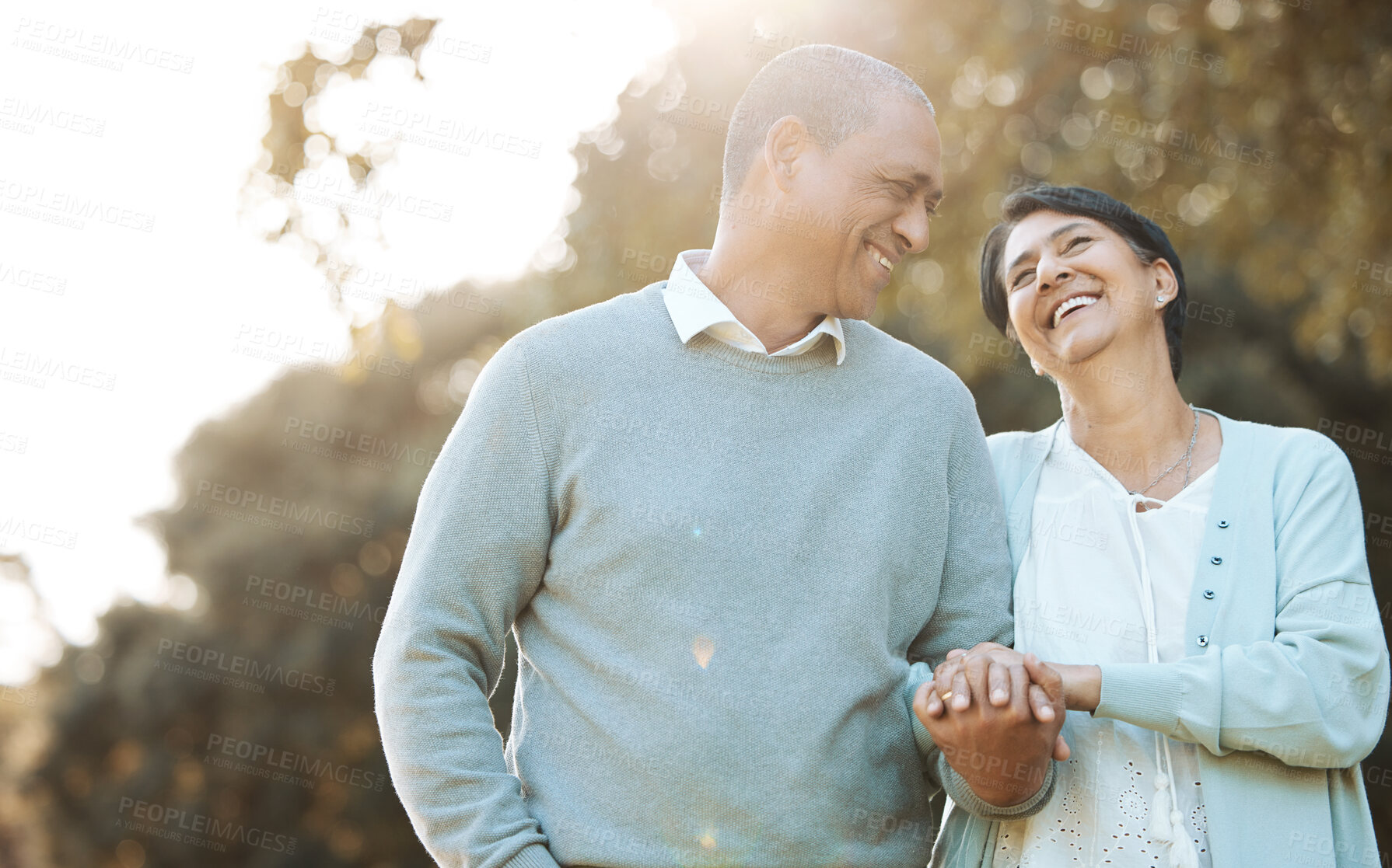 Buy stock photo Happy, love and senior couple in a park on an outdoor date for romance, bonding or love. Smile, talking and elderly man and woman in retirement in conversation walking in a field together at sunset.