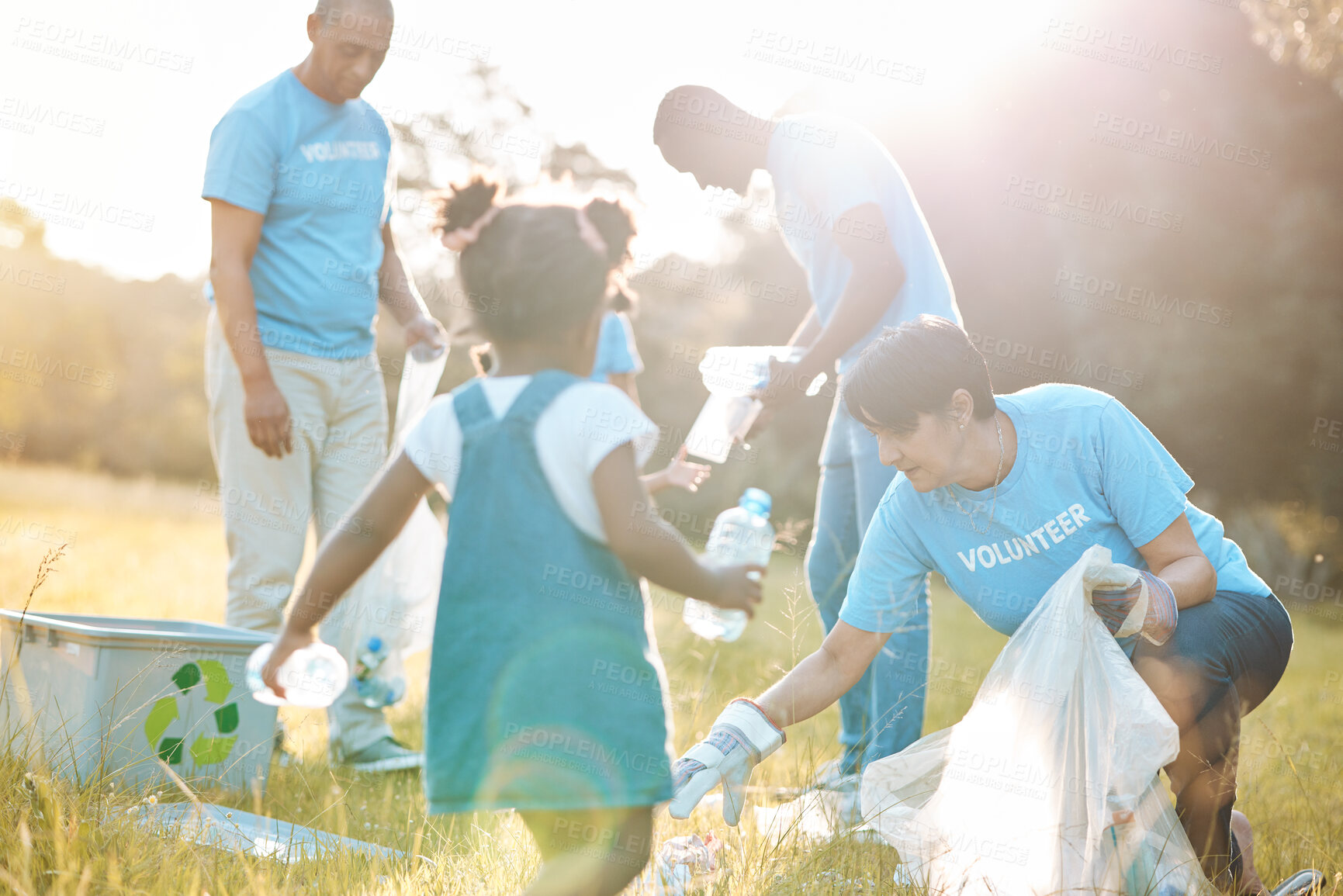 Buy stock photo Nature team, volunteering family and child cleaning garbage pollution, waste litter or plastic bottle. Group teamwork, NGO support and kid helping with park clean up, outreach project or field trash