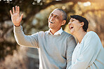 Happy, laugh and senior couple in a park on an outdoor date for romance, bonding or love. Smile, talking and elderly man and woman in retirement in conversation walking in a field together at sunset.