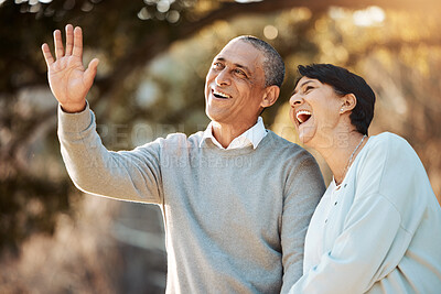 Buy stock photo Happy, laugh and senior couple in a park on an outdoor date for romance, bonding or love. Smile, talking and elderly man and woman in retirement in conversation walking in a field together at sunset.