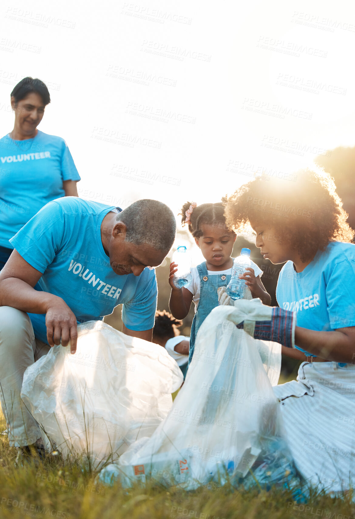 Buy stock photo Nature activist, volunteering and family cleaning garbage pollution, trash litter or throw plastic bottle in recycle bag. Eco collaboration, waste management and community group help with planet care