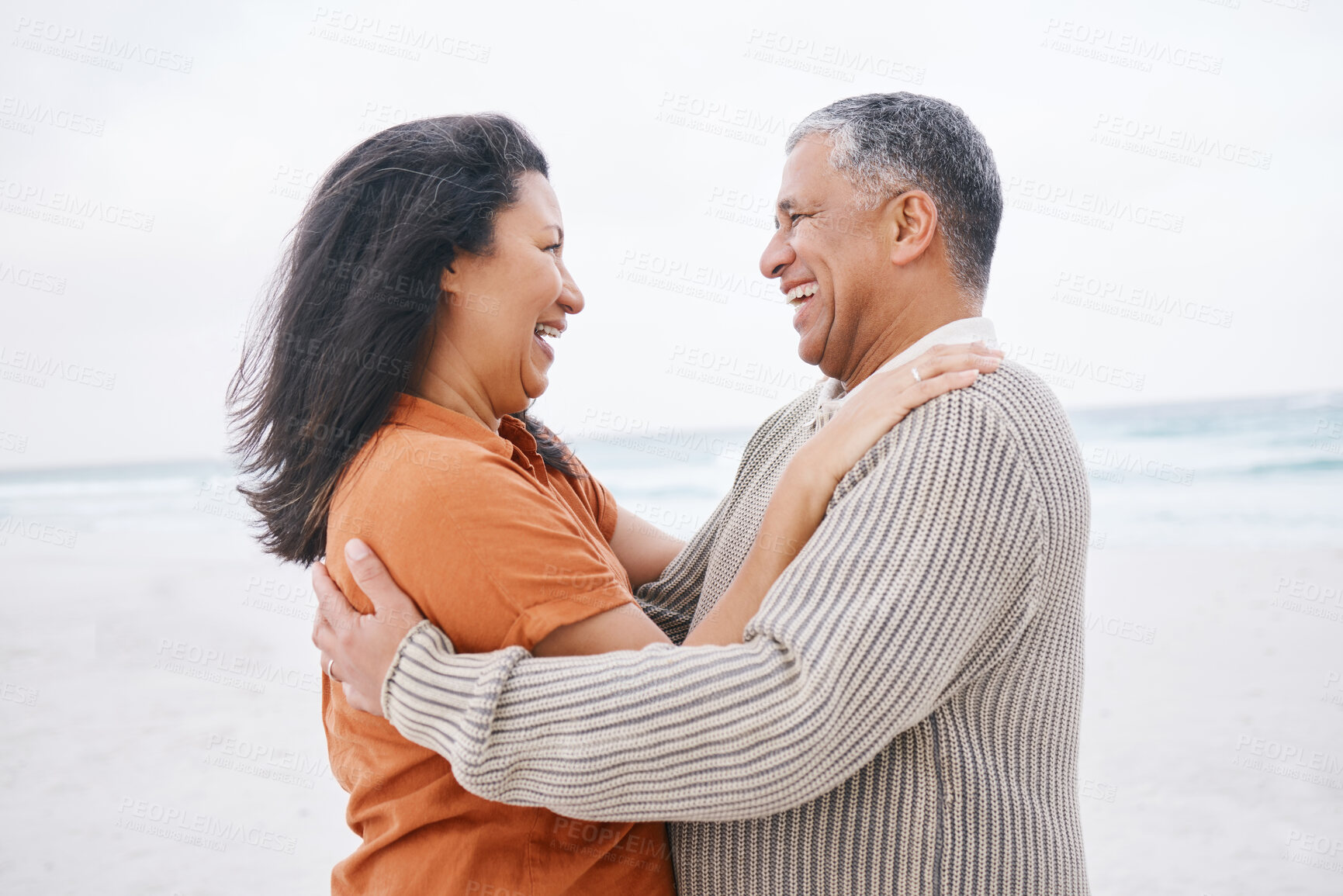 Buy stock photo Hug, beach and elderly couple laugh at funny conversation, retirement joke or anniversary humour in Mexico. Tropical winter date, comedy and romantic man, mature woman or people bond, embrace or care