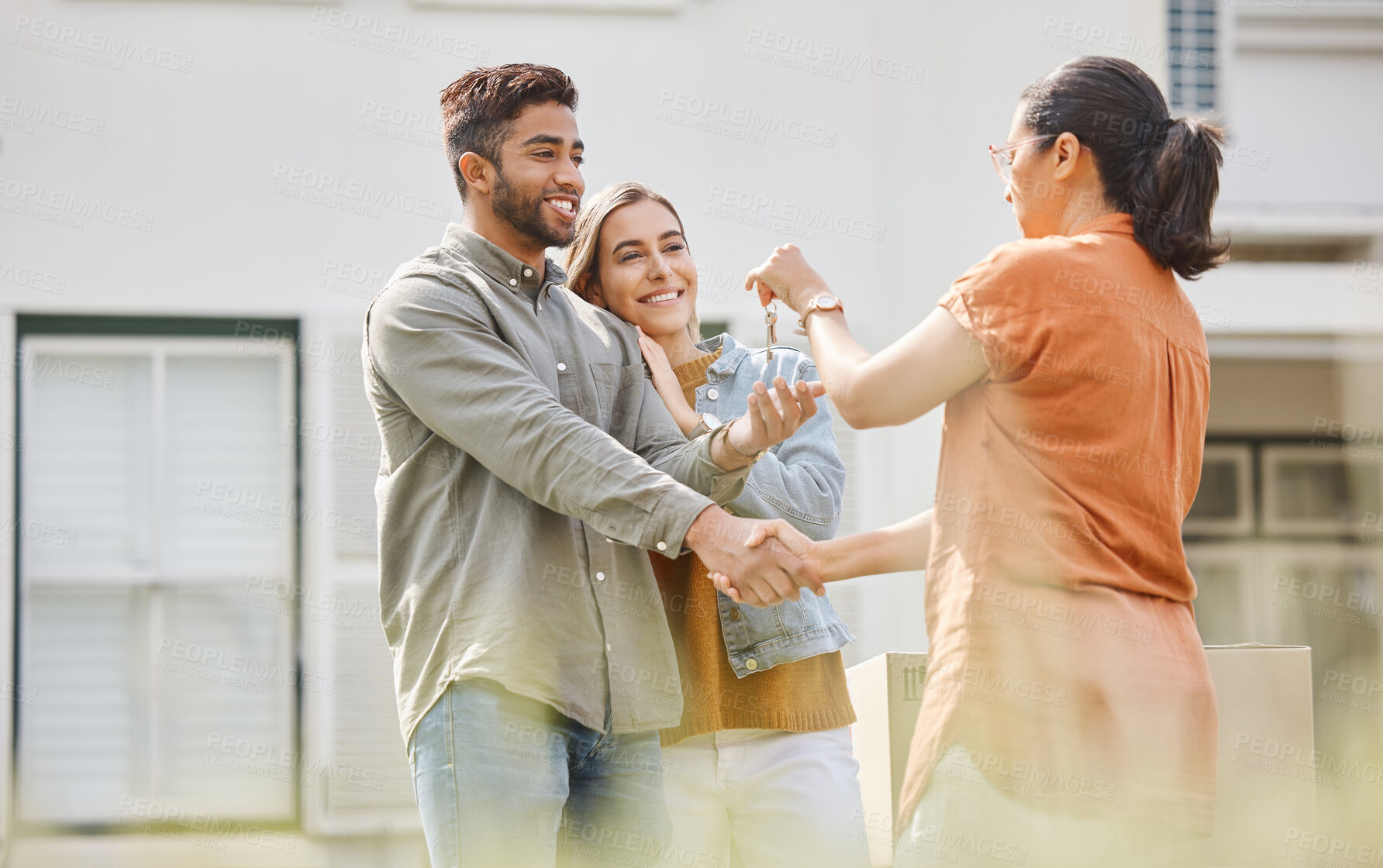 Buy stock photo House key, realtor woman and handshake with couple outdoor as congratulations, thank you or sale. Excited man, partner and shake hands with real estate agent for new home, mortgage or future property
