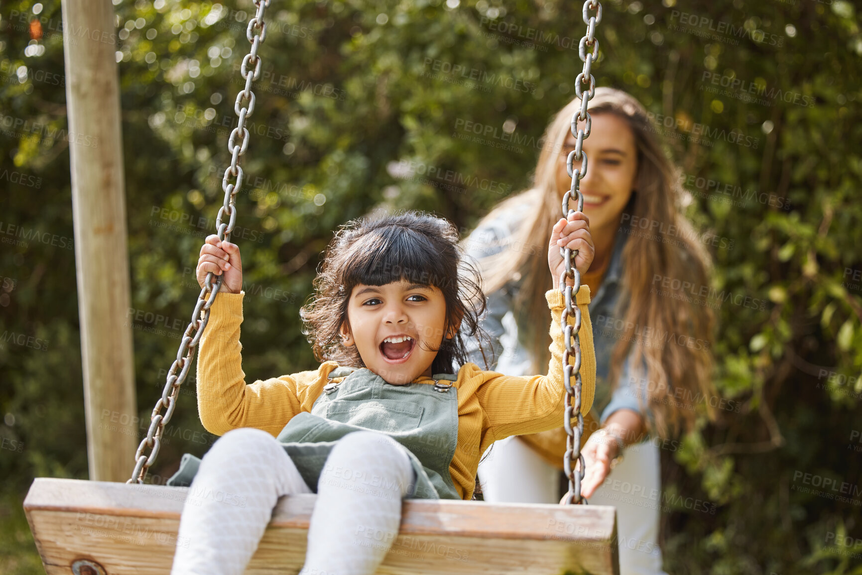 Buy stock photo Happy, swing and mother and child in park for playing, bonding and having fun together outdoors. Nature, weekend and mom push little girl in playground for relaxing, childhood and happiness in summer