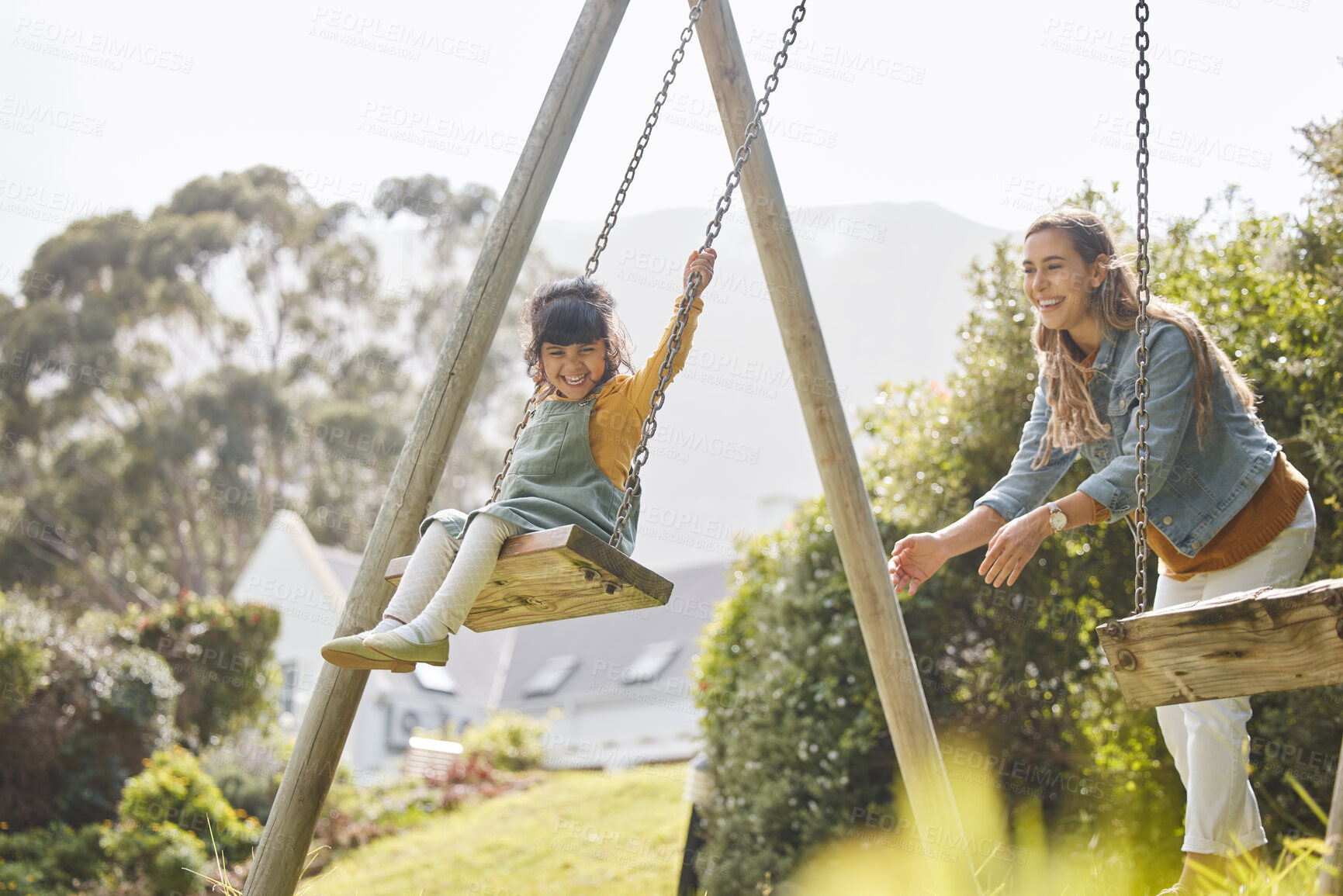 Buy stock photo Happy, swing and mother and girl in park for playing, bonding and having fun together outdoors. Nature, weekend and mom push daughter in playground for relaxing, childhood and happiness in summer