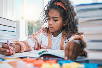 Buy stock photo Art, homework and child coloring in a book for artistic project, assignment or fun. Crayon, education and girl kid student writing for creative learning in a notebook by a desk at modern home.