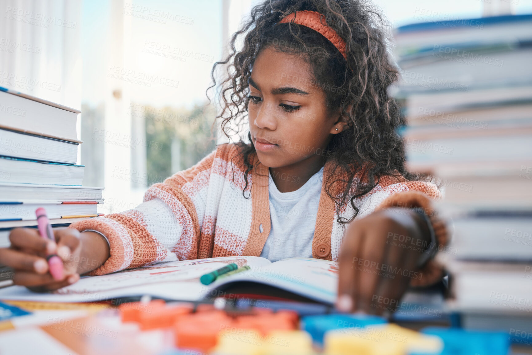 Buy stock photo Art, homework and child coloring in a book for artistic project, assignment or fun. Crayon, education and girl kid student writing for creative learning in a notebook by a desk at modern home.