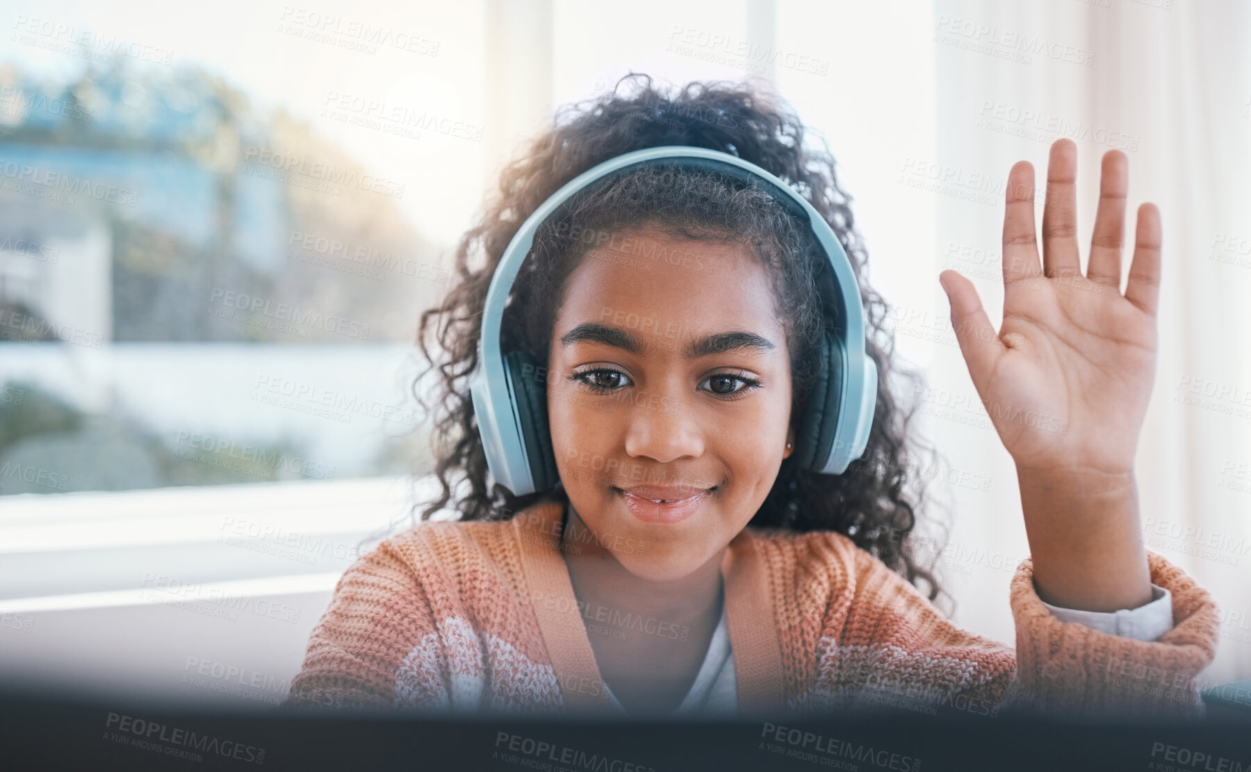 Buy stock photo Elearning, headphones and student on video call for online lesson for education or knowledge. Home school, technology and young girl child wave for hello on virtual class on laptop at her house.