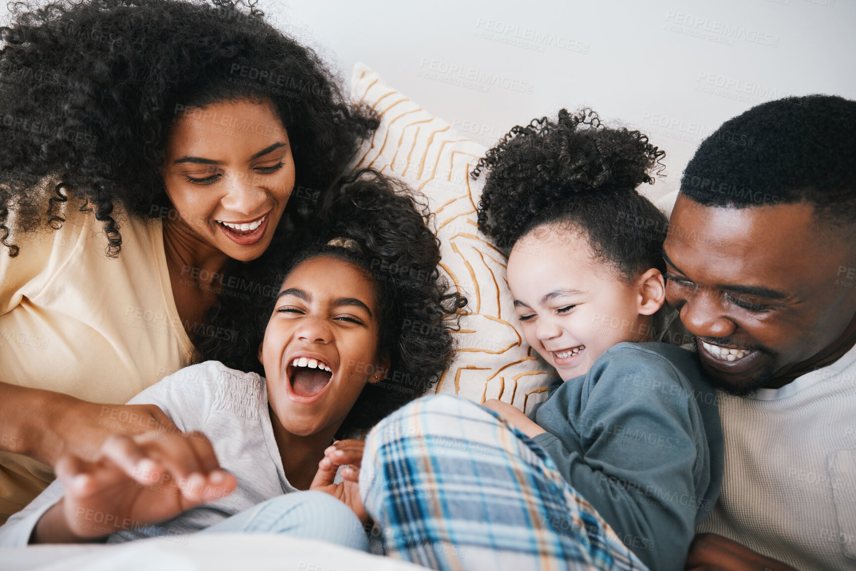 Buy stock photo Mom, dad and children in bed with tickling, comic joke and laugh with bonding, care and love in family home. Black man, mother and daughter with smile, play game or crazy in bedroom, morning or house