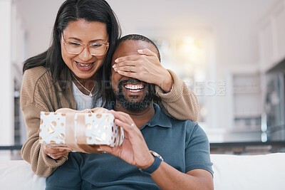 Buy stock photo Birthday gift surprise, cover eyes and happy couple giving Christmas package for love, congratulations or gratitude. Lounge sofa, support care and home man, woman or people celebrate with present box