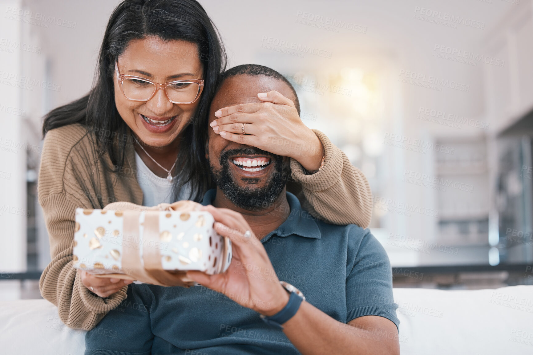 Buy stock photo Birthday gift surprise, cover eyes and happy couple giving Christmas package for love, congratulations or gratitude. Lounge sofa, support care and home man, woman or people celebrate with present box