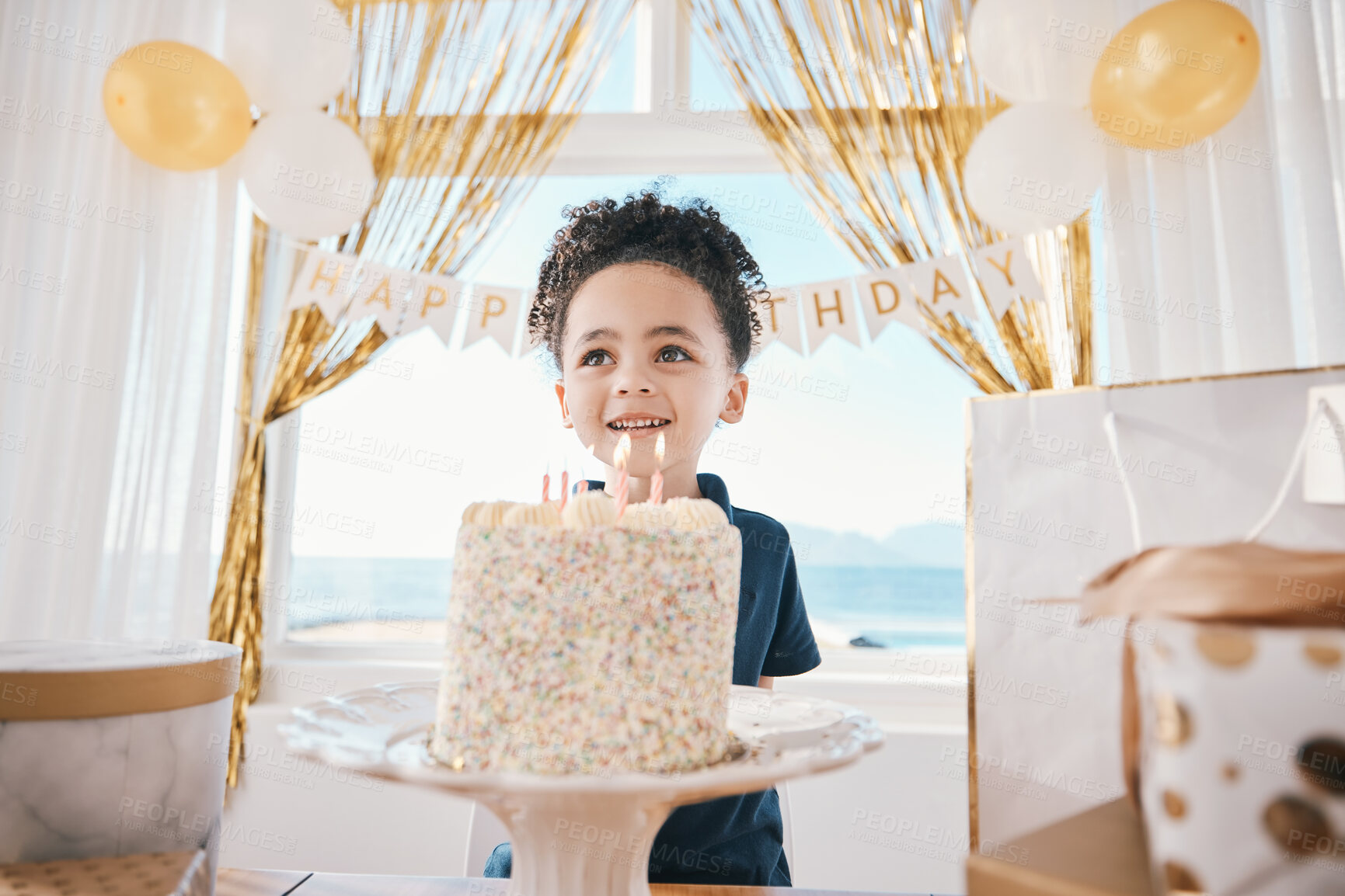 Buy stock photo Birthday party, cake and smile with child and candles for celebration, food and dessert. Excited, balloons and happy with young boy making wish in family home for surprise, gift and holiday event