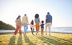 Nature, walking and back of big family holding hands, unity solidarity or bond on wellness holiday, travel or love. Sunshine flare, sky and relax kids, mom and dad support, trust and journey on grass