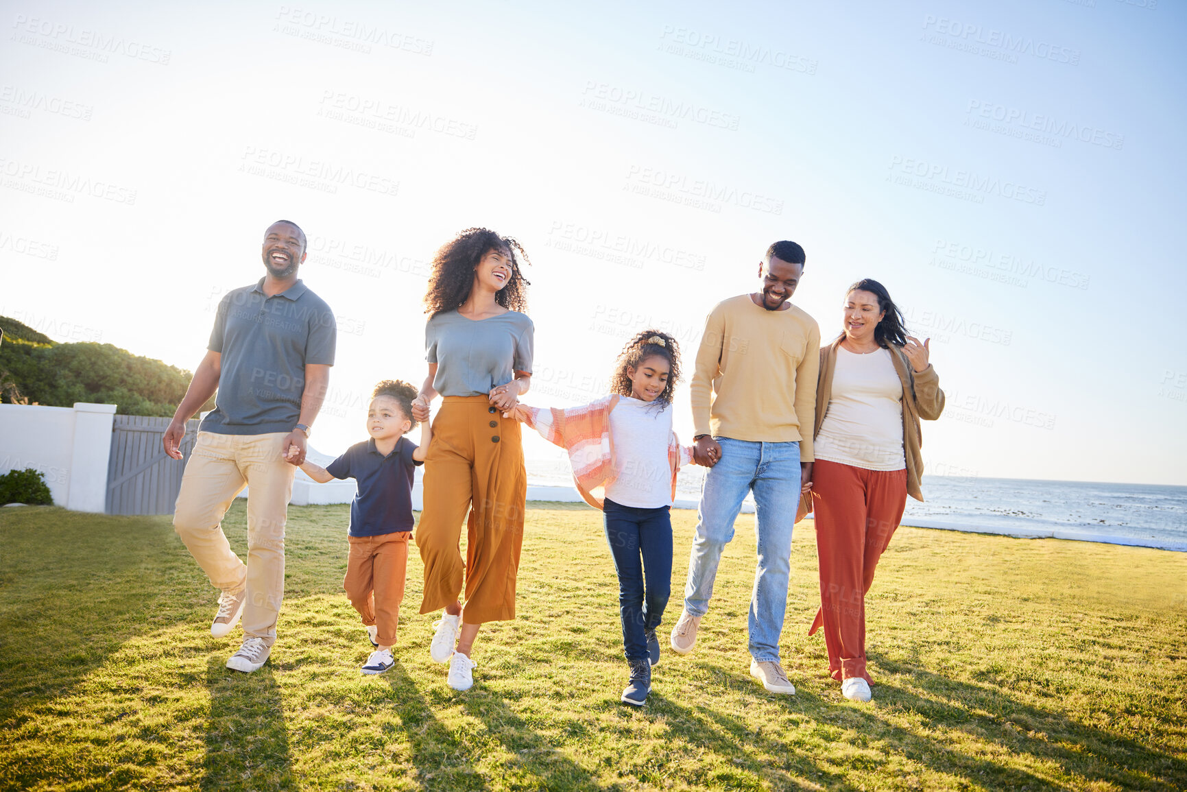 Buy stock photo Nature, kids walking and happy family holding hands, bonding and connect on outdoor holiday, travel and love. Summer sunshine, flare and relax children, mom and dad support, care and journey on grass