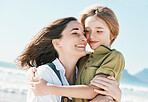 Family, mother and child hug on beach with blue sky for love, happiness and vacation in mauritius by ocean. Nature, woman and kid by sea in summer for holiday and adventure together with smile or joy