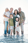 Grandparents, kids and big family with portrait at beach, hug or bonding for love, sunshine or excited in water. Men, women and children by sea, waves or happy embrace for holiday for summer in Spain