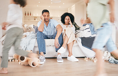 Buy stock photo Stress, chaos and parents on sofa with children running in the living room of family house. Headache, burnout and kids playing in the lounge with blur motion and young mom and dad at home in Mexico.