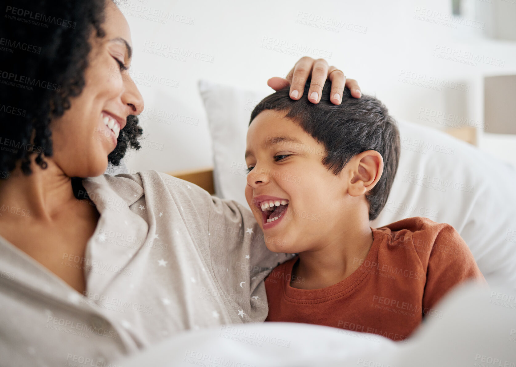 Buy stock photo Happy, funny and mother with son in bedroom for relax, morning routine or wake up. Smile, happiness and bonding with woman and child laughing in bed in family home for care, support and love together