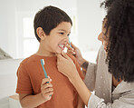 Toothbrush, smile and mom helping child with morning bathroom routine, dental care and cleaning. Mother, son and brushing teeth together in home with happy face, teaching and learning for children.