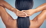 Hands, hair and keratin with a woman from the back in studio on a gray background for shampoo treatment. Beauty, spa or salon for haircare and a model closeup with natural and aesthetic growth