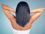 Beauty, hair and salon with a woman from the back in studio on a gray background for shampoo treatment. Luxury, spa or keratin for haircare and a model closeup with natural and aesthetic growth